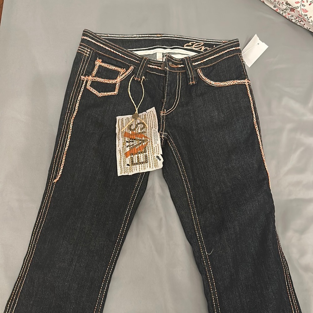 black elvis jeans with orange and white stitching. gorgeous stitching.